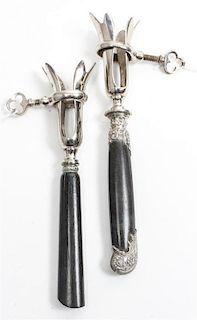 Two French Silver Mounted Bone Holders, makers' marks obscured, each having an ebony handle and a silvered metal clamp.
