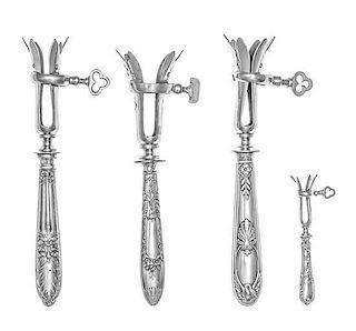 A Group of Four French Silver Bone Holders, various makers, the handles worked to show floral and ribbon swags, comprising th