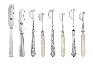 A Collection of Cheese Knives, various makers, having silver, silver-plate, ebony and mother-of-pearl handles.