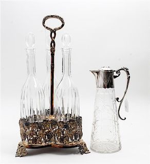 * A Silver-Plate and Glass Decanter Set Height overall 17 3/4 inches.