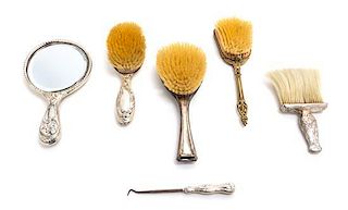 * An American Silver Dressing Set, Gorham Mfg. Co., Providence, RI, comprising a brush, a hand mirror, a powder brush and a b