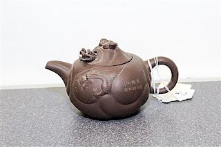 A Yixing Purple Stoneware Teapot and Cover Width 6 1/2 inches.