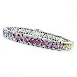 11.50 Carat Oval Cut Multi Color Sapphire, 2.25 Carat Diamond and 18 Karat White Gold Line Bracelet. Sapphires with vivid col