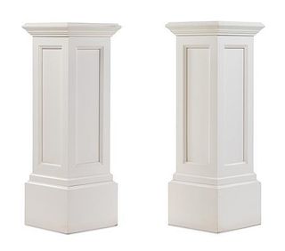 A Pair of White Painted Pedestals Height 39 1/4 x width 13 3/4 x depth 13 3/4 inches.