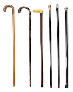 A Collection of Walking Sticks Height of tallest 36 inches.