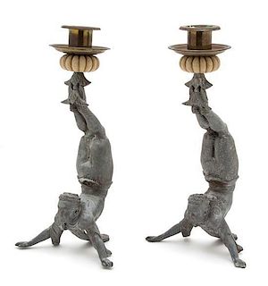 A Pair of Continental Cast Metal Acrobat Candlesticks Height 11 inches.