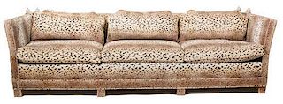 A Knole Style Leopard Print Upholstered Sofa Height 30 x width 105 inches.