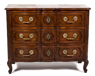 A Louis Provincial Style Walnut Three-Drawer Serpentine Commode Height 35 x width 43 x depth 19 inches.