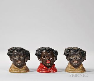 Three Ceramic Humidors, probably France, in the form of black men, one with a red shirt and two with white shirts.