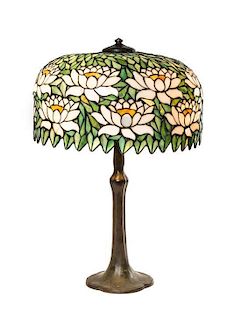 An American Leaded Glass and Bronze Table Lamp, Diameter of shade 18 1/2 x height overall 27 1/4 inches.
