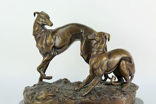 A finely crafted bronze statue of two hounds