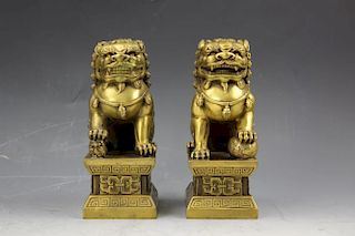 A pair of small brass foo lions