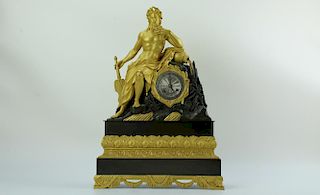 A shiny gilded brass clock with Dionysus holding a fan