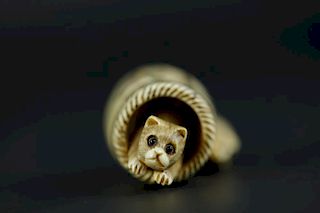 Vintage Netsuke carving of a cat in the barrel