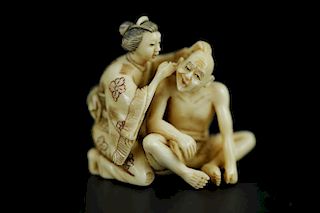 Vintage Netsuke carving of a woman cleaning a man's ear