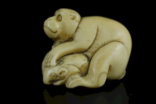 Vintage Netsuke carving of a man on top of a crab