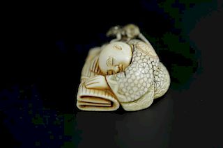 Vintage Netsuke carving of a scholar sleeping with a