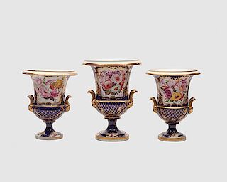 English Cobalt Ground Floral-Decorated Porcelain Three Piece Campagna Form Vase Garniture, 19th century