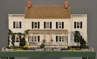 Large doll house on stand with twelve fully furnished rooms. total ht. 72in. table top: 28" x 60"