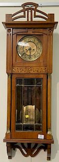 Walnut regulator clock with brass dial and two brass weights. ht. 38in., wd. 12in.