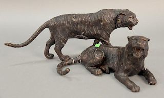 Two bronze tiger figures, one lying down (lg. 13 1/2in.) and the other walking (lg. 20in.).