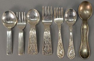 Seven piece lot of silver baby spoons and forks including Cartier two piece set, Tiffany ABC two piece set, Reed and Barton t