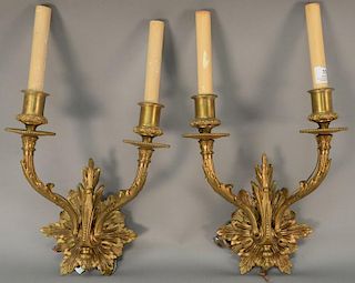 Set of four French style bronze wall sconces, each having two candle form lights with shades. ht. 18in., wd. 10in.