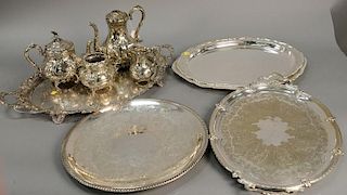 Group of silver plate to include five large silver plated trays and a four piece tea set, lg. 22in. to 28in.