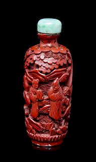 A Carved Cinnabar Lacquer Snuff Bottle, Height of bottle 3 inches.