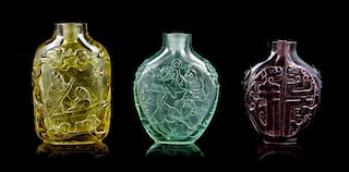 A Group of Three Peking Glass Snuff Bottles, Height of tallest 2 5/8 inches.