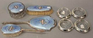 Eight piece lot to include a four piece silver enameled dresser set marked sterling and four sterling and crystal coasters ma