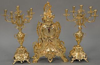 French style brass three piece clock set. candelabra ht 17 3/4in., clock ht. 19in.