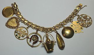 JEWELRY. 14kt Gold Charm Bracelet with 9 Various