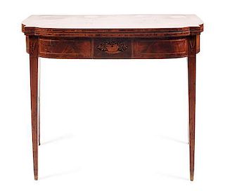 An American Mahogany Federal Card Table, New England, Height 29 1/4 x width 35 1/4 x depth (closed) 17 5/8 inches.