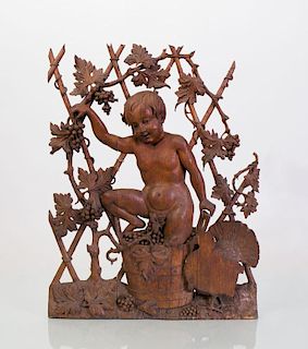 CONTINENTAL CARVED AND PIERCED OAK WALL PANEL OF A CHILD PRESSING GRAPES