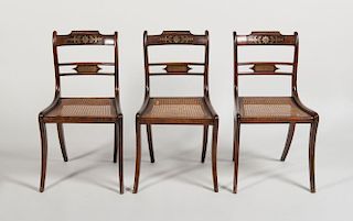 SET OF THREE REGENCY STYLE BRASS-INLAID GRAINED AND CANED SIDE CHAIRS