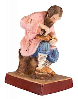 A RUSSIAN PORCELAIN FIGURE OF A SHOEMAKER, GARDNER PORCELAIN FACTORY, MOSCOW, LATE 19TH CENTURY