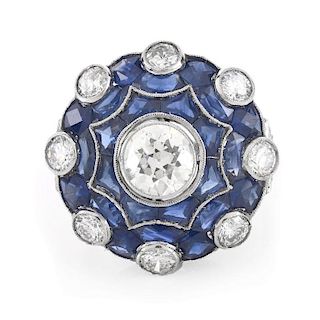 Art Deco Approx. 4.0 Carat TW Old European Cut Diamond, Calibre Cut Sapphire and Platinum Ring. Set in the center with an app