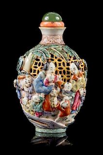 A Molded Famille Rose Porcelain Snuff Bottle Height 3 1/2 inches.