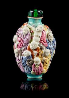 A Molded Famille Rose Porcelain Snuff Bottle Height 3 1/8 inches.