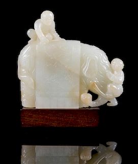 * A Pale Celadon Jade Figure of an Elephant and Boys Height 3 1/2 inches.