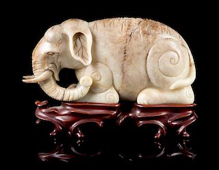 * A Mottled Jade Figure of an Elephant Length 7 inches.