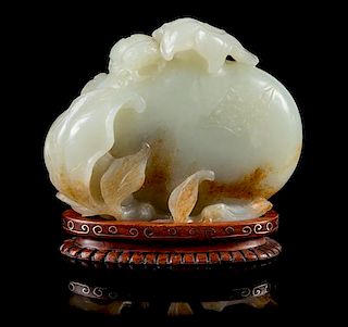 * A Pale Celadon and Russet Jade Model of Pomegranates Height 3 inches.