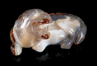 A Carved Agate Figure of a Recumbent Fu Lion Length 5 1/4 inches.