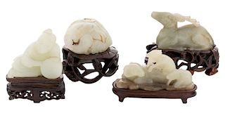 FOUR CHINESE WHITE JADE FIGURES ON STANDS (LATE QING DYNASTY)