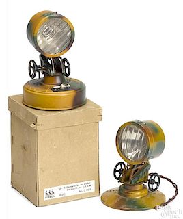 Two Lineol camouflage painted tin search lights