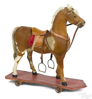 Hide covered horse platform pull toy