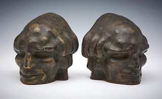 Pair of bronze bookends, face of a man, Rubinstein foundry