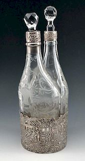 Fine two-bottle etched glass decanters in silver base