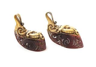 A Pair of Carved Hornbill Earrings, Width of wider at widest 4 inches.